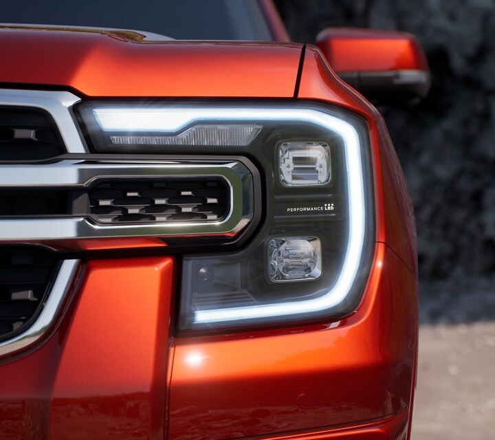 A close-up of the LED Projector Headlamps of a 2024 Ford Ranger® in Hot Pepper Red