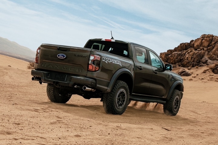A 2024 Ford Ranger® Raptor® truck parked on a sand dune in a scenic location