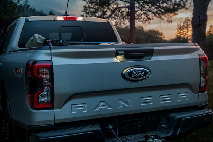 A 2024 Ford Ranger® LARIAT® truck with a close-up of the LED taillamps at dusk