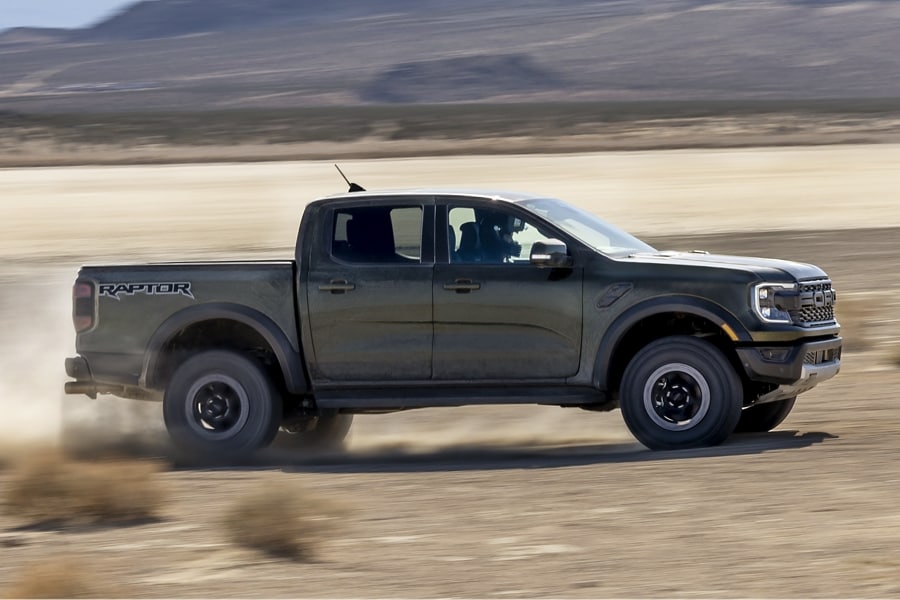 A 2024 Ford Ranger® truck is being driven off-road with the mountains in the background