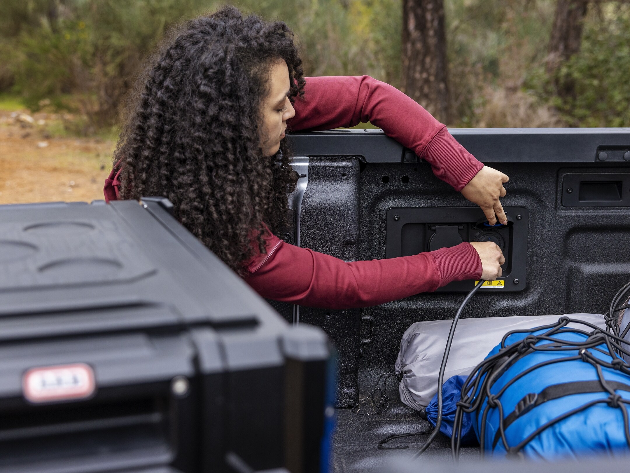 A person is using the 400-Watt outlet in their parked 2024 Ranger® truck bed