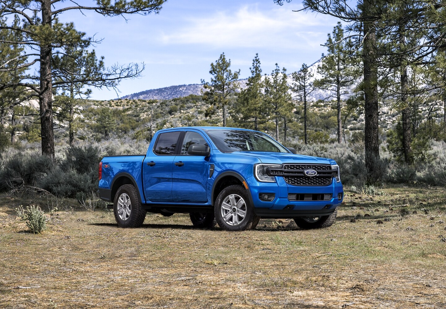 A 2024 Ford Ranger® is parked on a dirt road surrounded by mountains