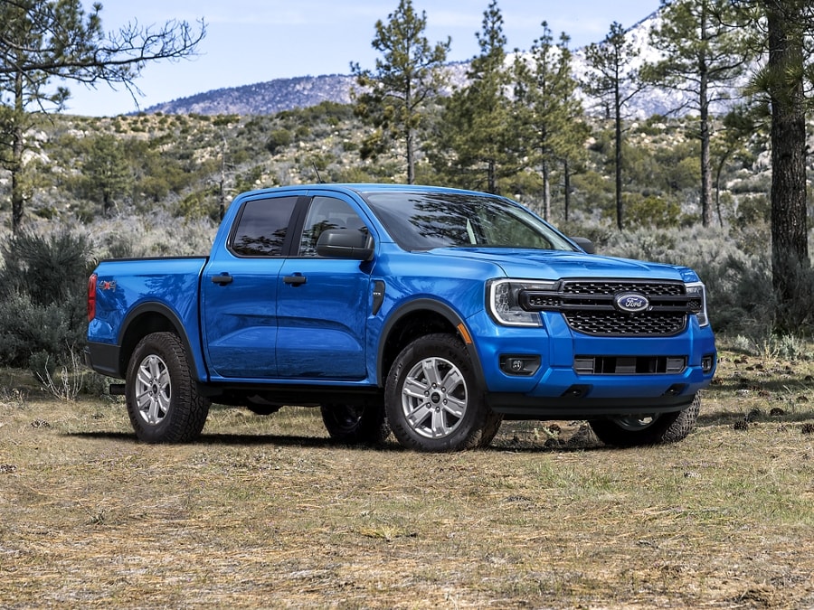 A 2024 Ford Ranger® in Velocity Blue parked at the base of a mountain