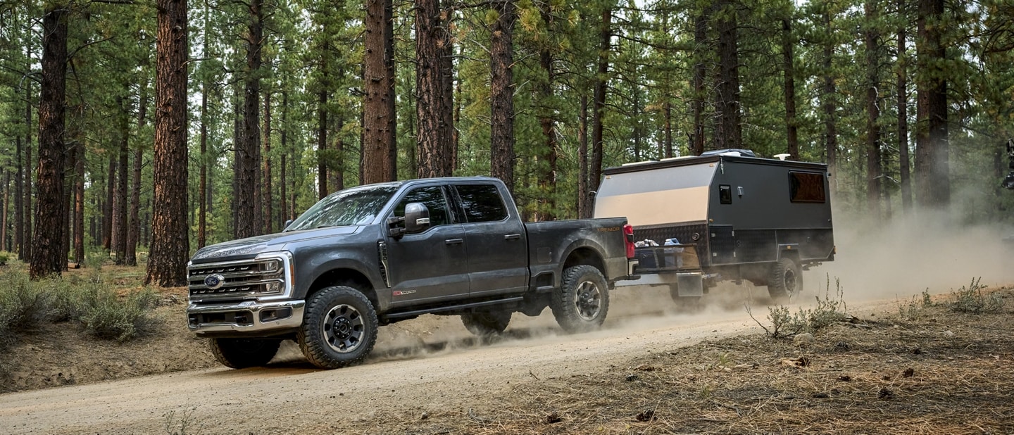 2023 Ford Super Duty® F-250® Tremor® pulling a small camper trailer