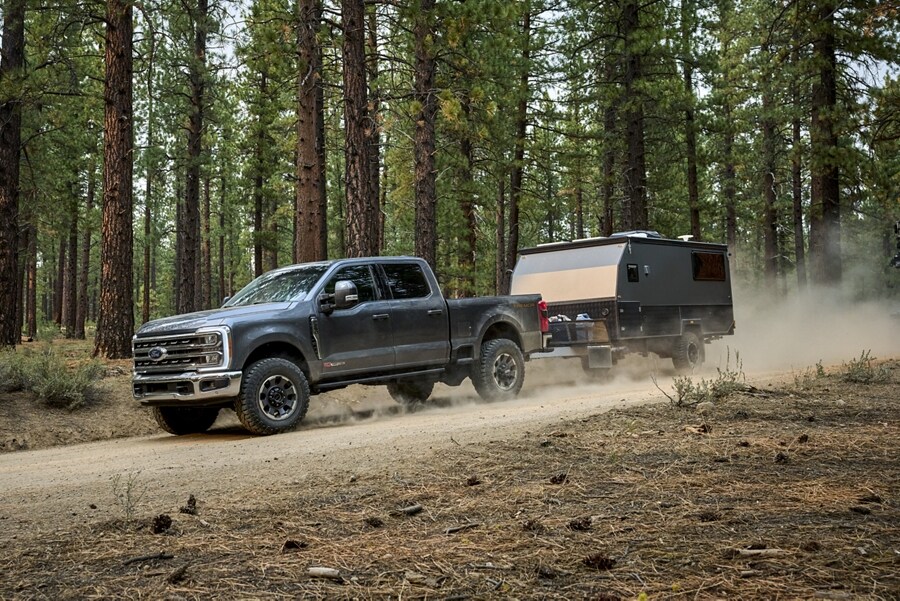 2023 Ford Super Duty® F-250® Tremor® pulling a small camper trailer