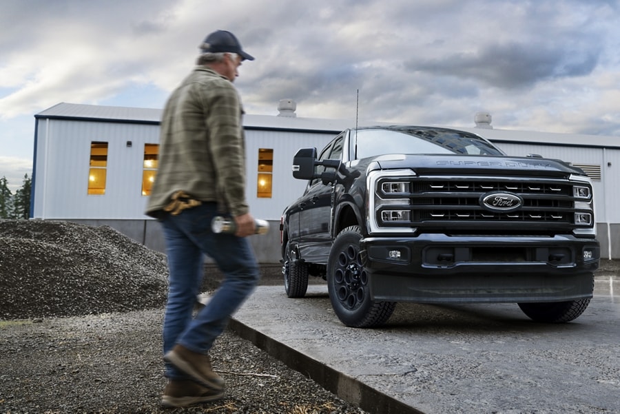Man walking near a 2023 Ford Super Duty® truck with Black Appearance Package