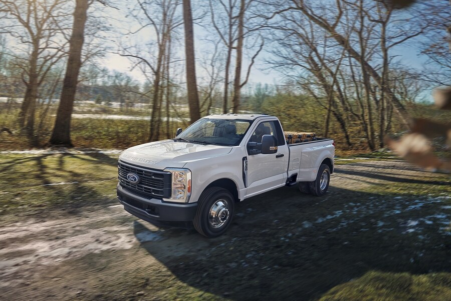 2023 Ford Super Duty® F-350® XL in a nature setting and hauling cargo in the bed of the truck