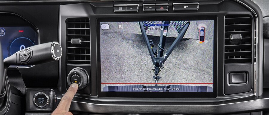 Close-up of a person pressing the Pro Trailer Hitch Assist button