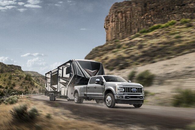 2024 Ford Super Duty® F-450® Limited pulling a camper trailer on a mountain roadway