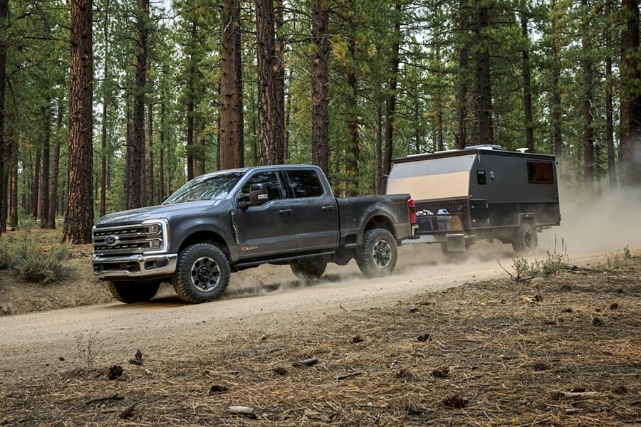 2024 Ford Super Duty® F-250® Tremor® pulling a small camper trailer