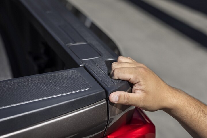 Primer plano de una persona con la mano en el espacio para agarrarse de la plataforma de la camioneta Ford Super Duty® 2023