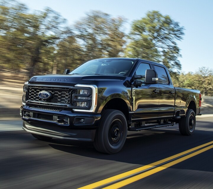 Image of a 2024 Super Duty® XL STX Sport Appearance Package pickup being driven on a road