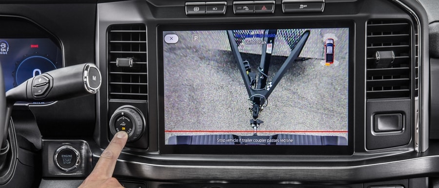 Close-up of a person pressing the Pro Trailer Hitch Assist button