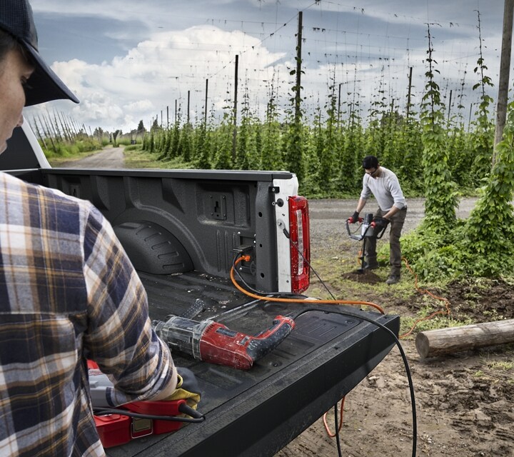 Two workers using the Pro Power Onboard feature with power tools