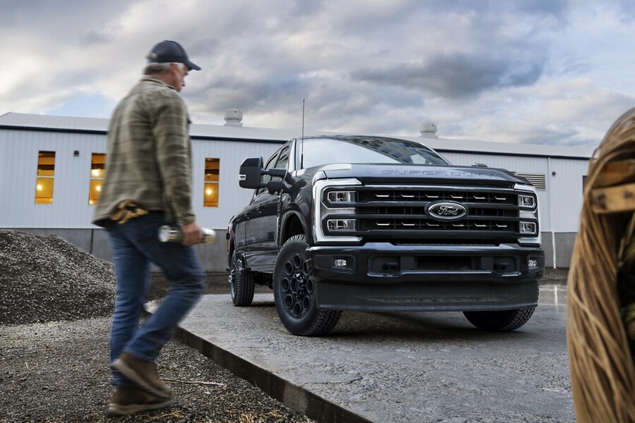 Man walking toward a parked 2024 Ford Super Duty® F-450® Limited