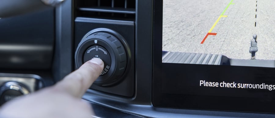 Close-up of a person pushing the pro trailer hitch assist button in a 2024 Ford Super Duty® pickup