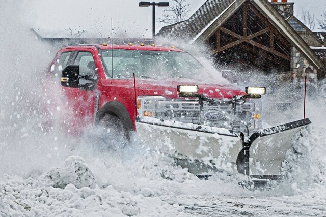 2025 Ford Super Duty® Commercial pickup with the snow plow prep package plowing through snow