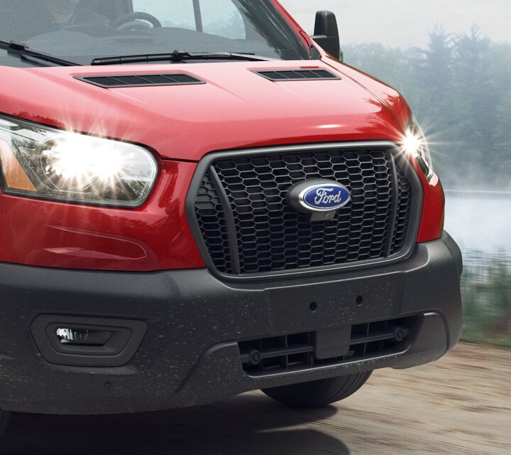Side view of a 2023 Ford Transit® Chassis Cab being driven down a dirt road