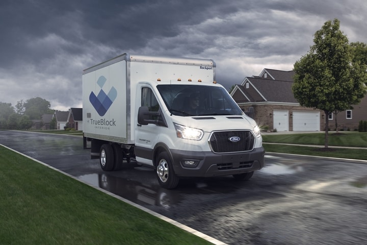 2023 Ford Transit® Cutaway parked in a driveway at a house with construction workers