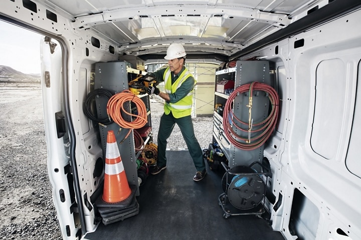A construction worker in the back of a 2023 Ford Transit® van