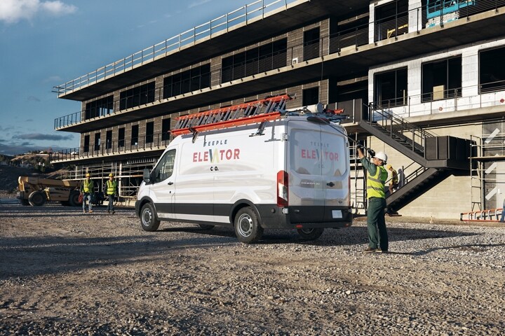 Rear three quarter view of the Transit® van at a construction site