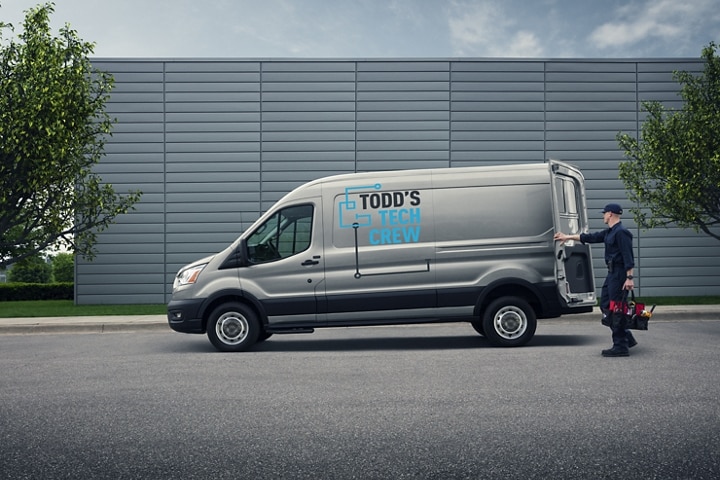A worker closing the rear of a 2023 Ford Transit® van in Ingot Silver