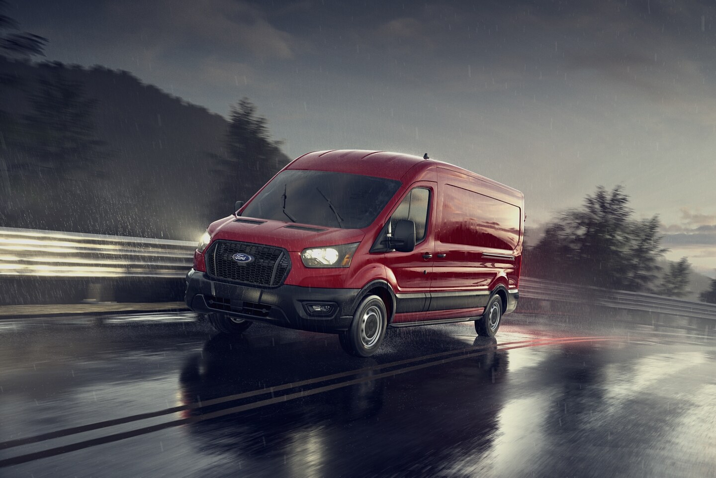 Red 2024 Ford Transit box truck driving down wet rainy highway