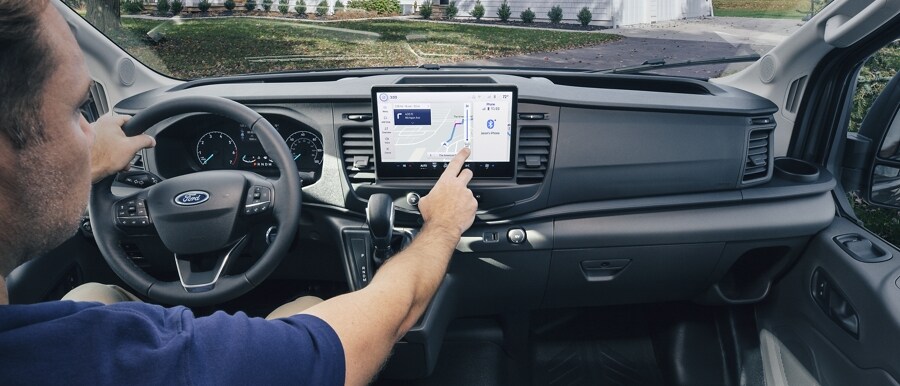 A man using touch screen navigation in a 2023 Ford Transit® Cargo Van