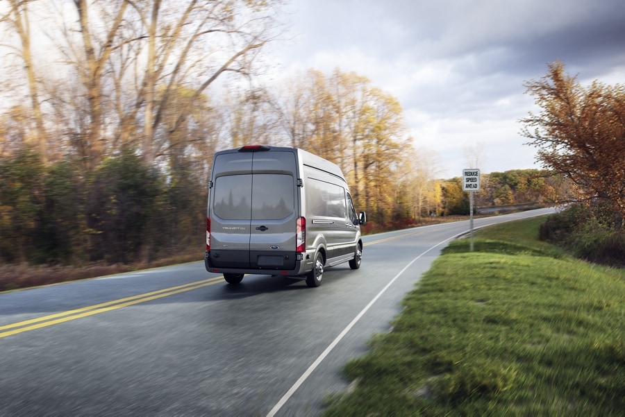 Rear view of a 2023 Ford Transit® Van driving on a highway