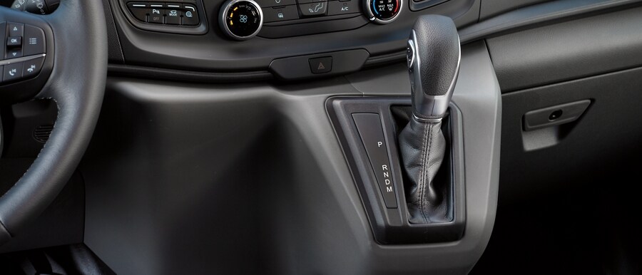 Interior shot of the center console right shifter in a 2023 Ford Transit® van