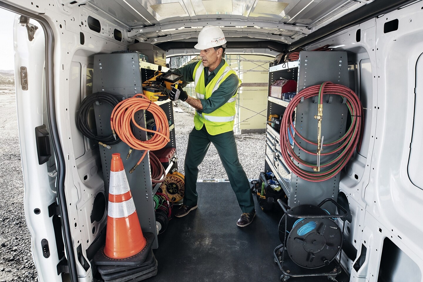 Man gathering gear from 2024 Ford Transit Van