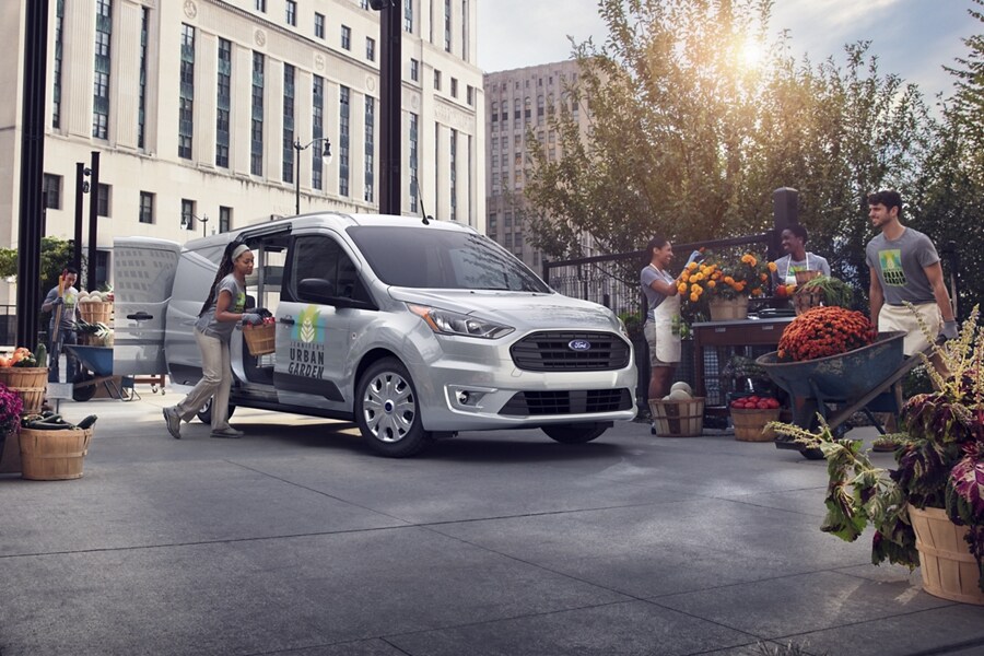 People at a flower market putting the 2023 Ford Transit Connect Cargo Van to work