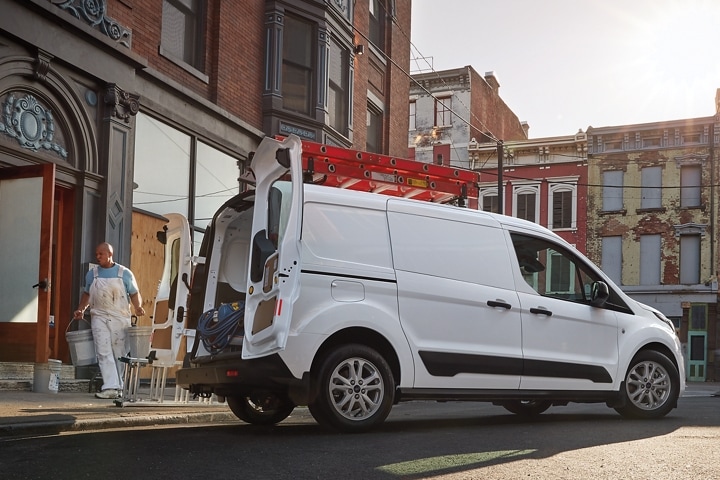 A commercial painter on the job with a 2023 Ford Transit Connect Cargo Van