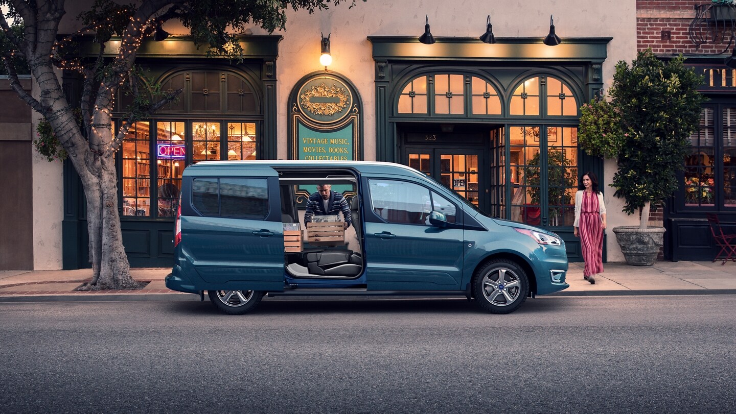 2023 Ford Transit Connect Passenger Wagon parked on city street during the daytime with opened dual sliding side doors