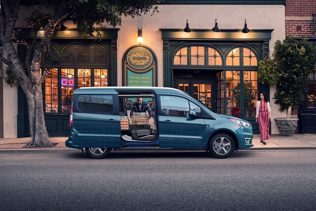 2023 Ford Transit Connect Passenger Wagon parked on city street during the daytime with opened dual sliding side doors