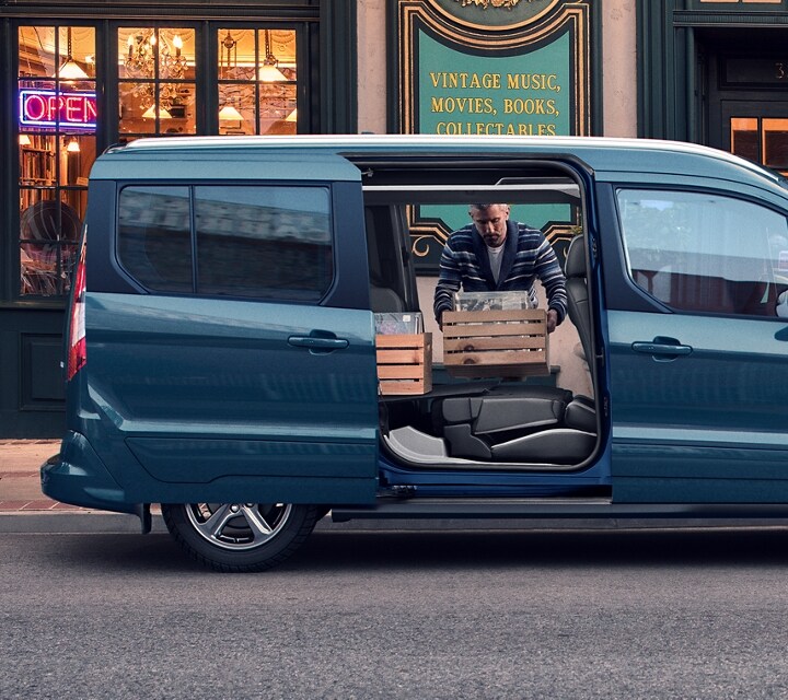 2023 Ford Transit Connect Passenger Wagon parked on city street with opened dual sliding side doors