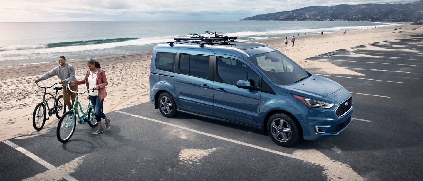 2023 Ford Transit Connect Passenger Wagon in Blue Metallic parked by the beach