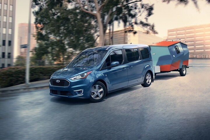 2023 Ford Transit Connect Passenger Wagon towing a trailer in the city