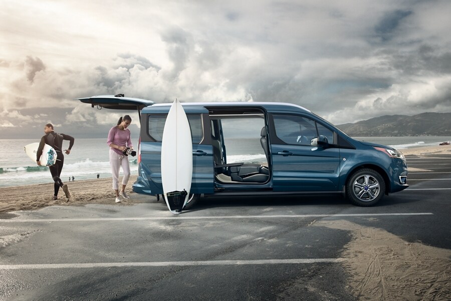 2023 Ford Transit Connect Passenger Wagon on the beach with open dual sliding side doors and rear liftgate
