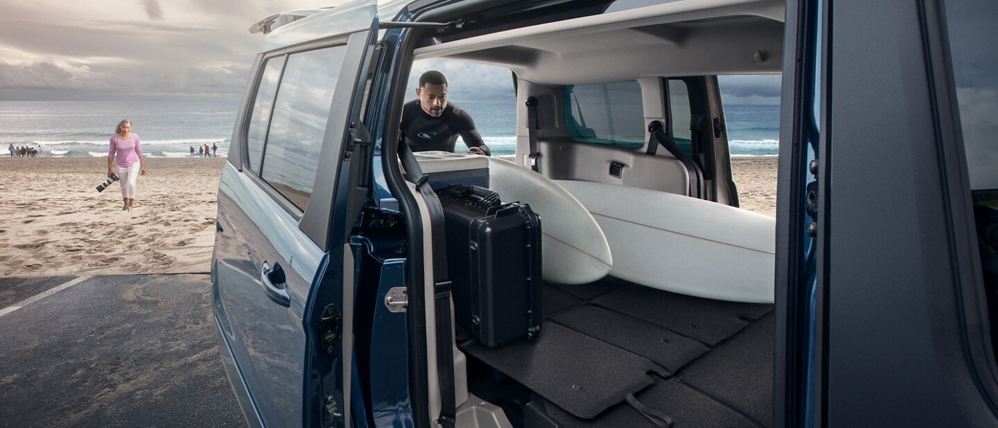 Man loading surfboards into 2023 Ford Transit Connect Passenger Wagon