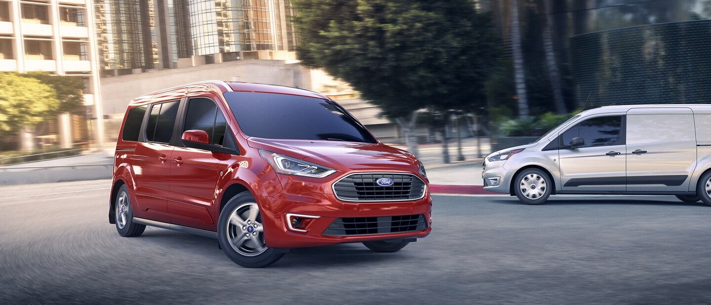 A 2023 Ford Transit Connect Passenger Wagon and a 2023 Ford Transit Connect Cargo Van on the street in the city