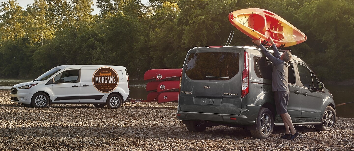The versatile 2023 Ford Transit Connect Passenger Wagon in Magnetic with a man loading kayaks
