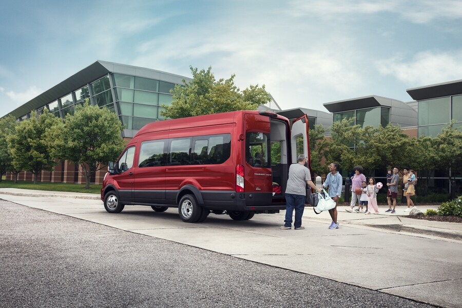 People loading luggage in the back of a 2023 Ford Transit® van