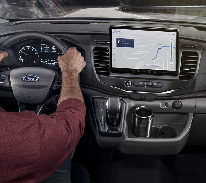 The interior of a 2023 Transit® van with a person behind the wheel