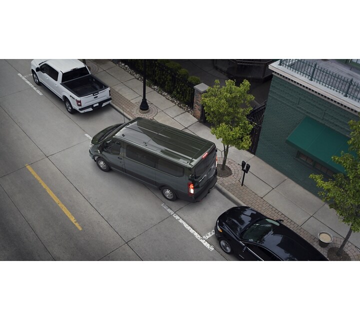 A 2023 Ford Ford Transit® van being parallel parked