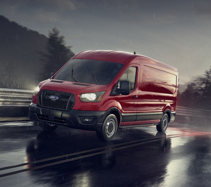 A 2023 Ford Transit® van being driven on a suburban street