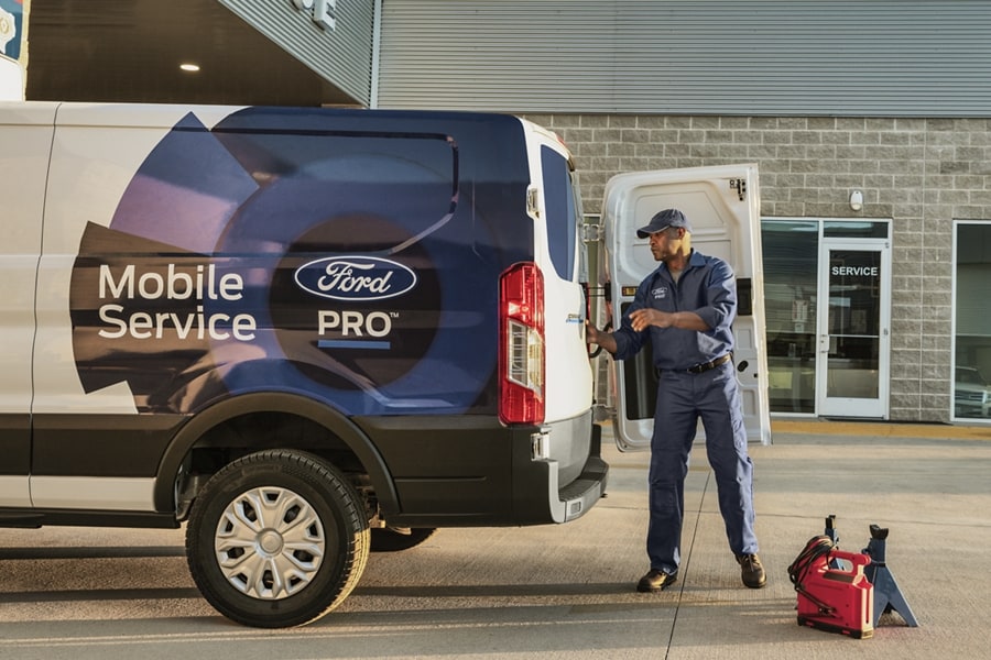 Ford Pro™ Mobile Service van with a man unloading tools from the rear